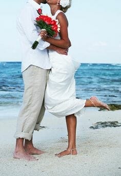 Groom barefoot on the beach