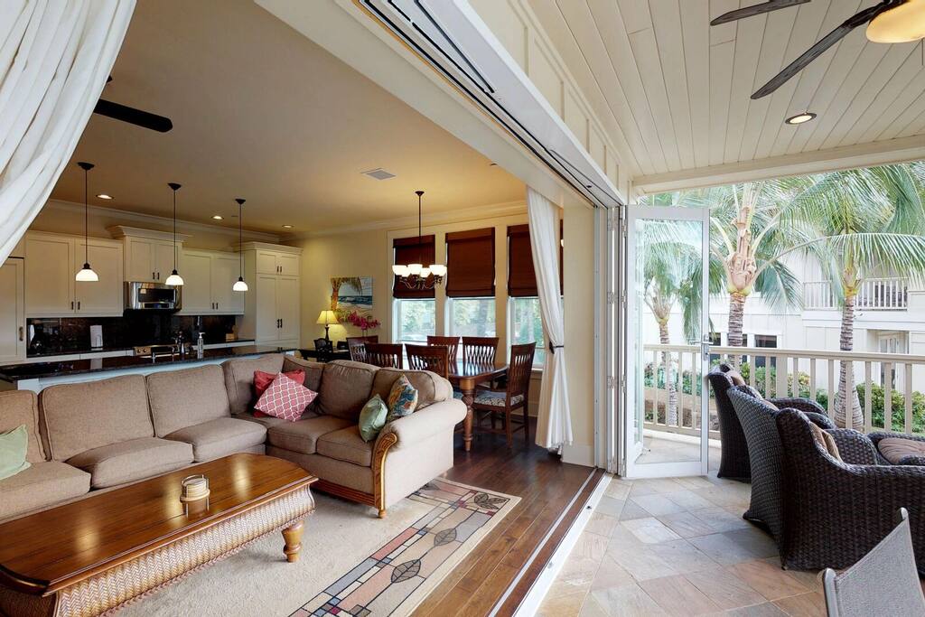Cozy living room with sliding door leading to patio at Kauai Villas.