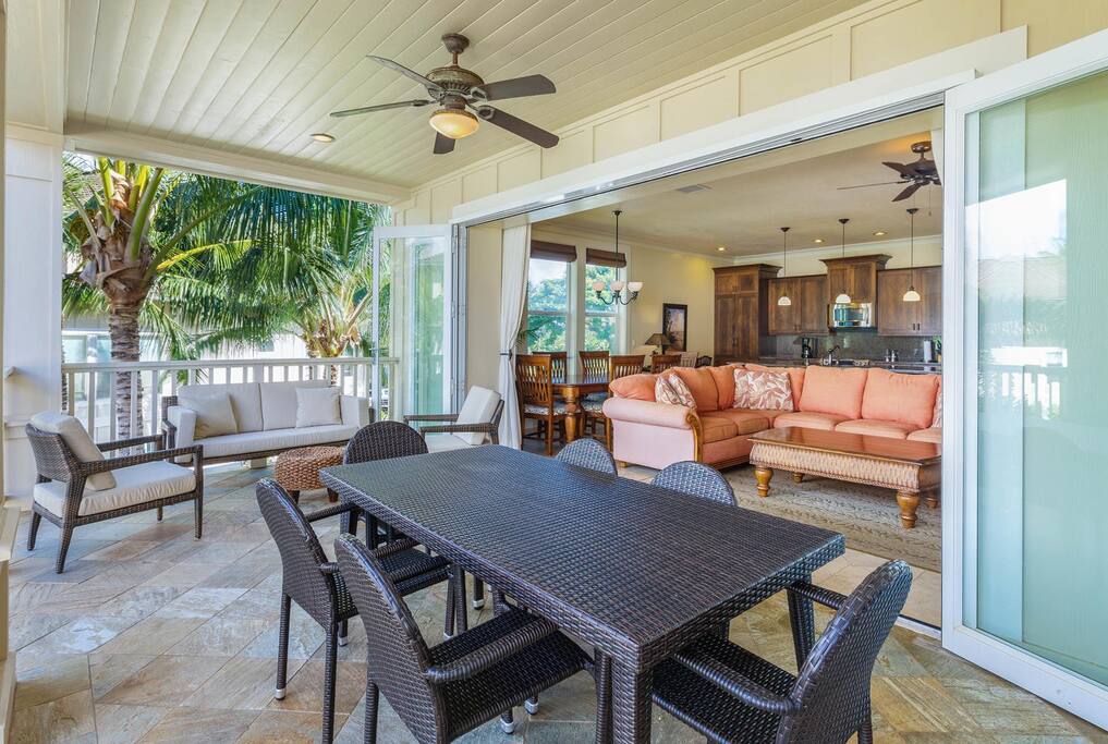 A spacious covered patio at Kauai Villas, featuring furniture and a ceiling fan for ultimate comfort.