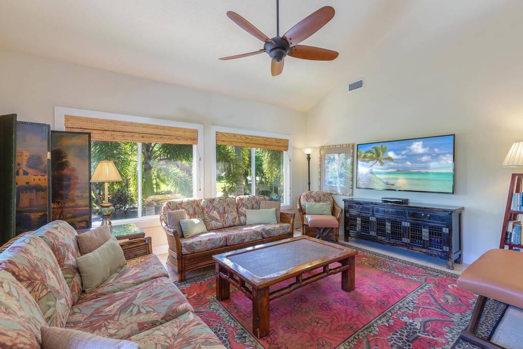 Living room in Kauai Villas featuring a spacious area with a large flat-screen TV.